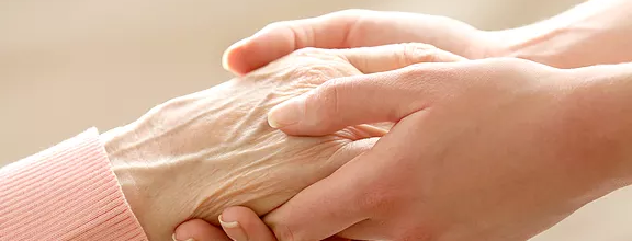 Hands offering care — metaphor for social services delivery